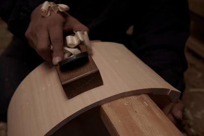 Wood pieces are processed with a plane.